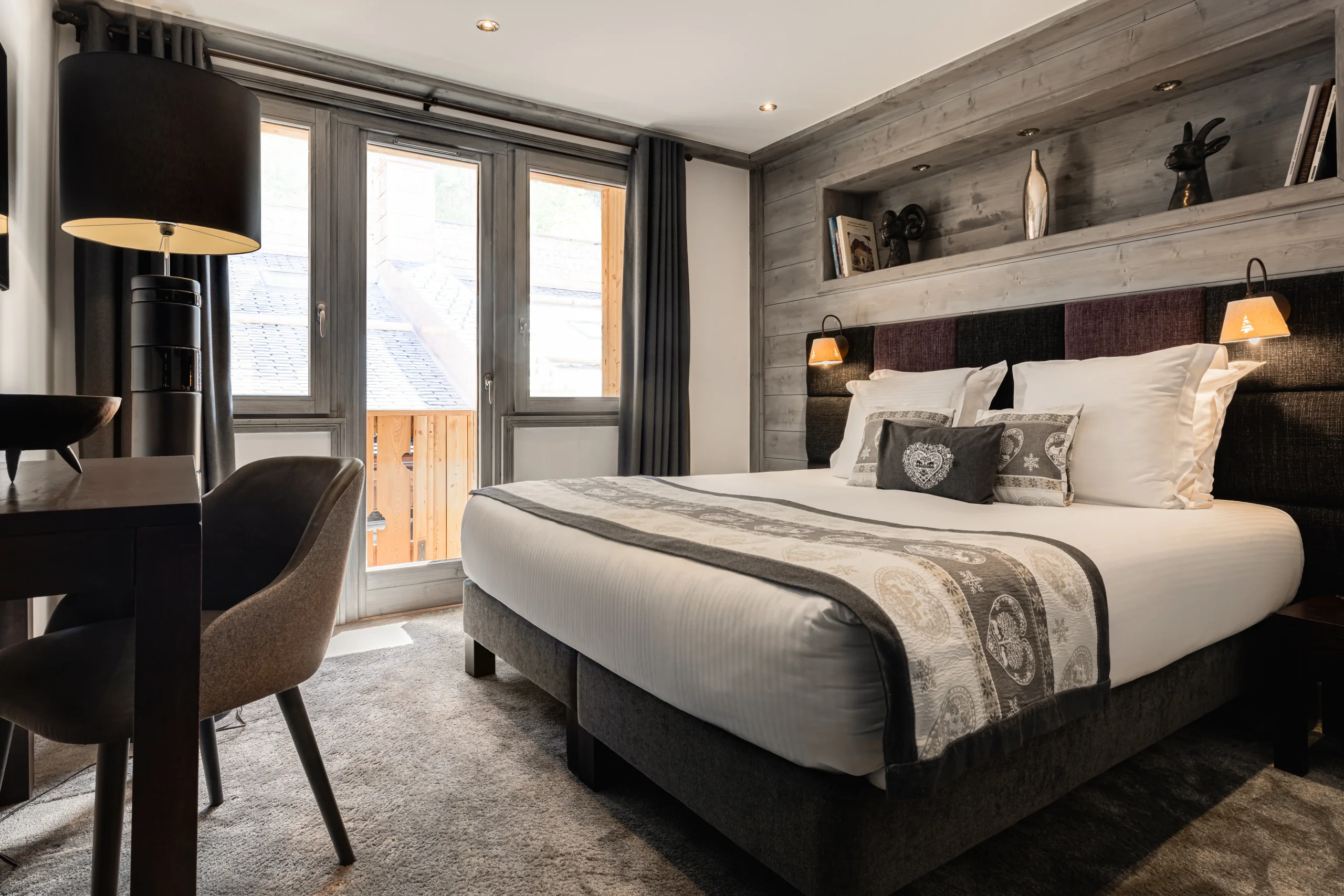 Chambre avec lit double et accès au balcon à l’Hôtel La Chaudanne, hôtel 4 étoiles à Méribel.