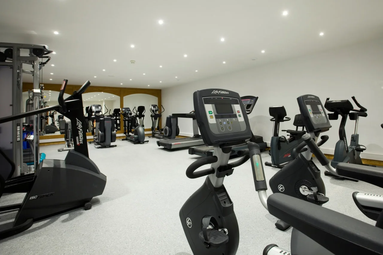 Salle de fitness de l’Hôtel La Chaudanne avec vélos d’appartement, tapis de course et appareils de musculation.